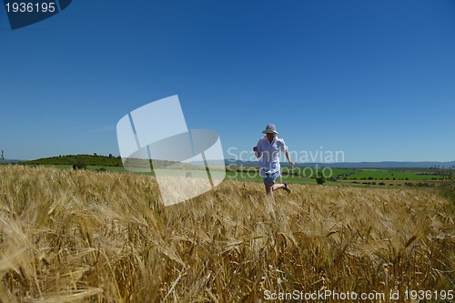 Image of young woman in wheat field at summer