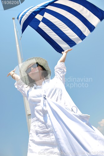 Image of Greek woman on the streets of Oia, Santorini, Greece