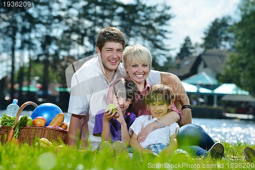 Image of Happy family playing together in a picnic outdoors