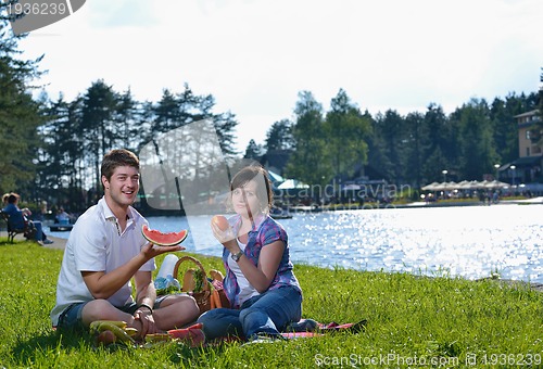 Image of happy young couple having a picnic outdoor