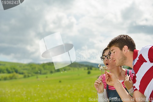 Image of Portrait of romantic young couple smiling together outdoor