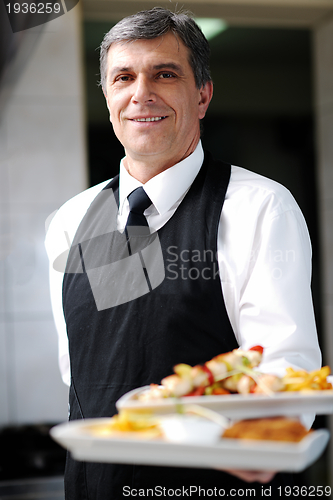 Image of male chef presenting food