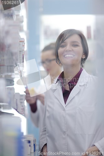 Image of pharmacist chemist woman standing in pharmacy drugstore