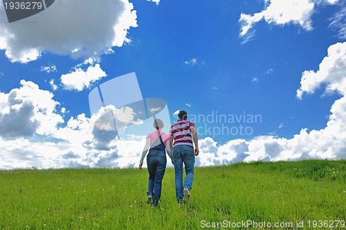 Image of Portrait of romantic young couple smiling together outdoor