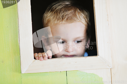 Image of happy child in a window