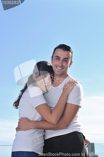 Image of couple relaxing on balcony