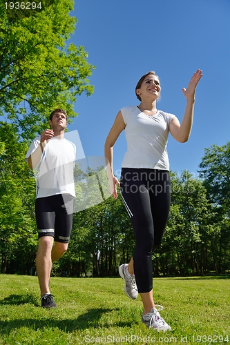 Image of Young couple jogging at morning