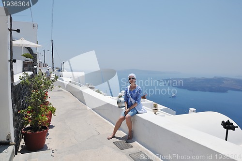 Image of Greek woman on the streets of Oia, Santorini, Greece