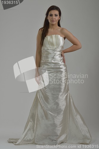 Image of elegant woman in fashionable dress posing in the studio