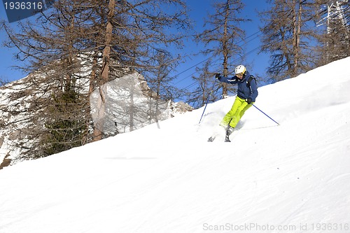 Image of skiing on fresh snow at winter season at beautiful sunny day