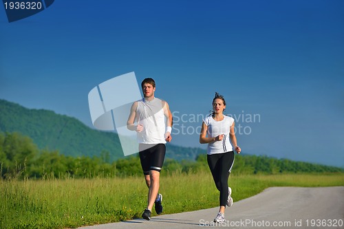 Image of Young couple jogging at morning