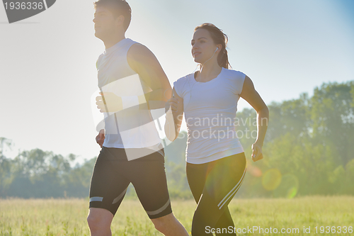 Image of Young couple jogging at morning