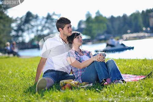 Image of happy young couple having a picnic outdoor
