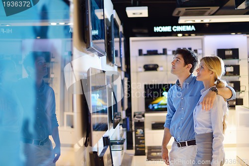 Image of Young couple in consumer electronics store