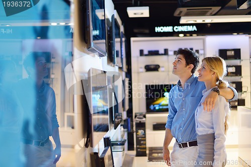 Image of Young couple in consumer electronics store