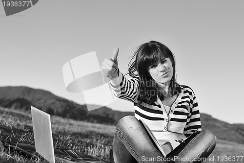 Image of young teen girl work on laptop outdoor
