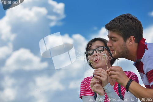 Image of Portrait of romantic young couple smiling together outdoor