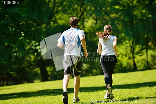 Image of Young couple jogging at morning