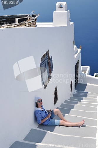 Image of Greek woman on the streets of Oia, Santorini, Greece