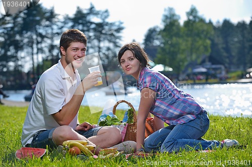 Image of happy young couple having a picnic outdoor