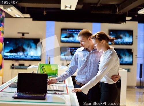 Image of Young couple in consumer electronics store