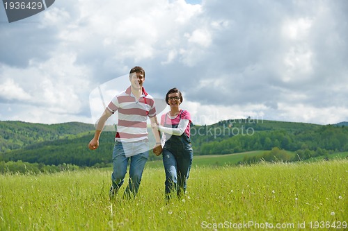 Image of Portrait of romantic young couple smiling together outdoor