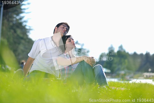 Image of happy young couple having a picnic outdoor