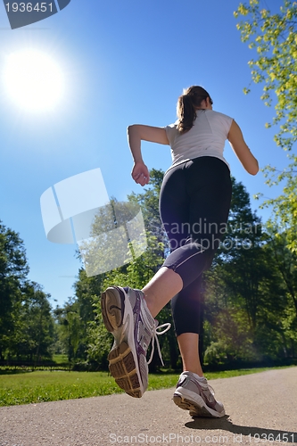 Image of Young beautiful  woman jogging at morning in park