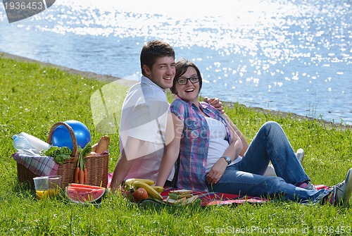Image of happy young couple having a picnic outdoor