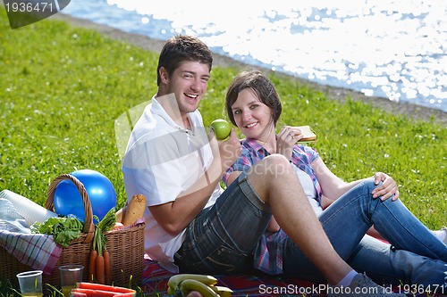 Image of happy young couple having a picnic outdoor