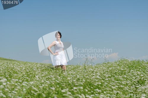 Image of Young happy woman in green field