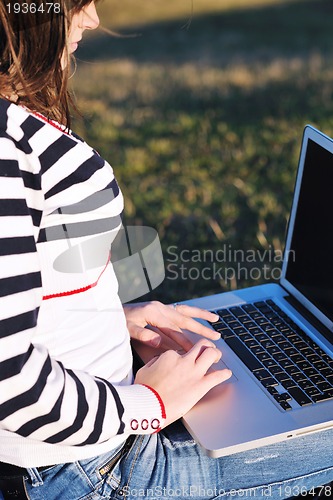 Image of young teen girl work on laptop outdoor