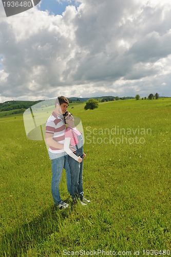 Image of Portrait of romantic young couple smiling together outdoor