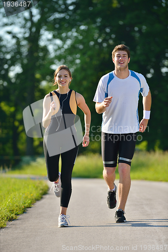 Image of Young couple jogging at morning