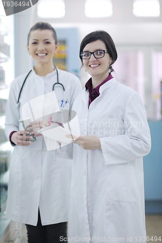 Image of team of pharmacist chemist woman  in pharmacy drugstore