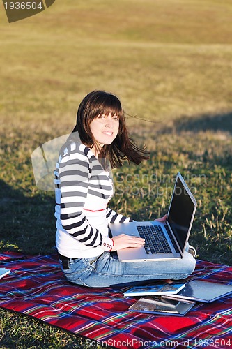 Image of young teen girl work on laptop outdoor
