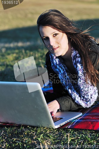 Image of young teen girl work on laptop outdoor