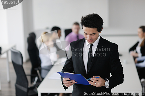 Image of young business man at meeting