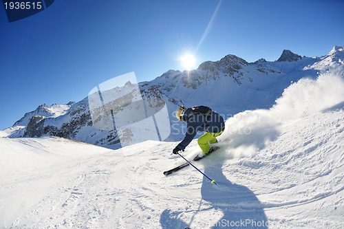 Image of skiing on fresh snow at winter season at beautiful sunny day