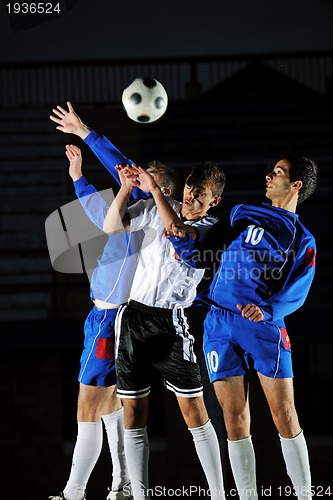 Image of football players in action for the ball