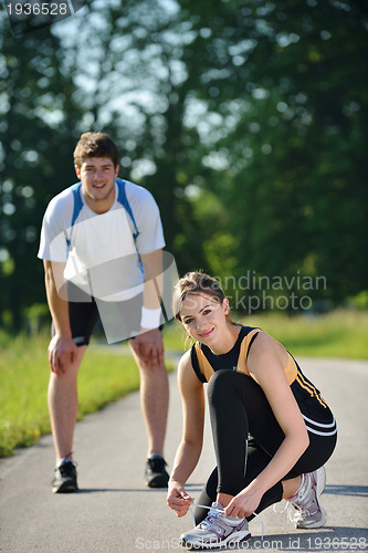 Image of Young couple jogging at morning