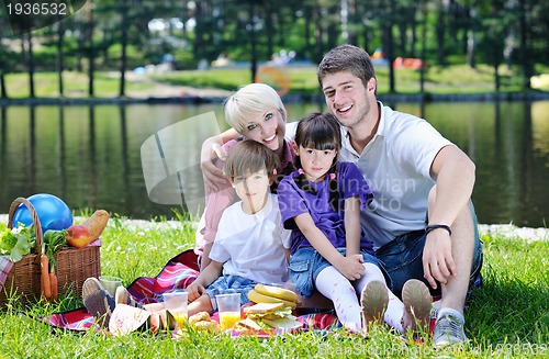 Image of Happy family playing together in a picnic outdoors