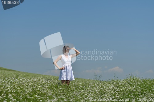 Image of Young happy woman in green field