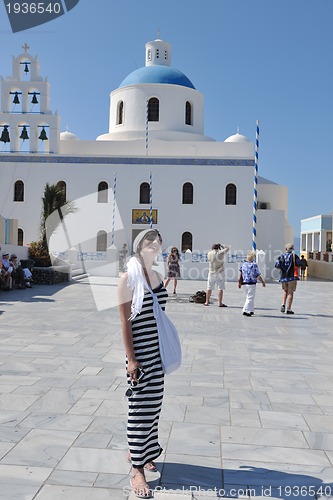 Image of Greek woman on the streets of Oia, Santorini, Greece