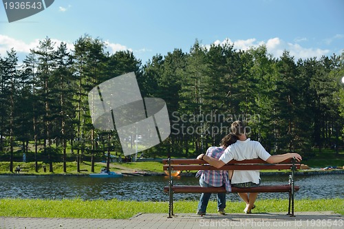 Image of Portrait of romantic young couple smiling together outdoor