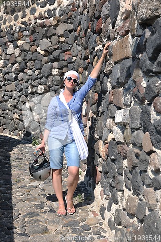 Image of Greek woman on the streets of Oia, Santorini, Greece