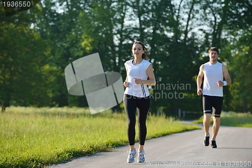 Image of Young couple jogging at morning