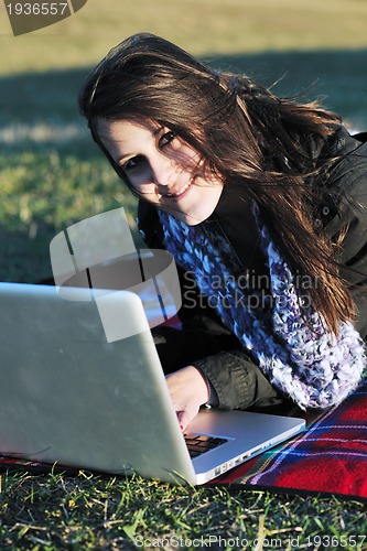 Image of young teen girl work on laptop outdoor