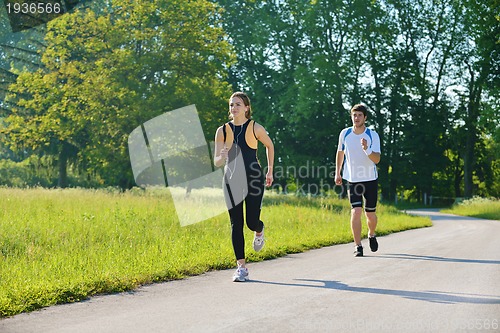 Image of Young couple jogging at morning