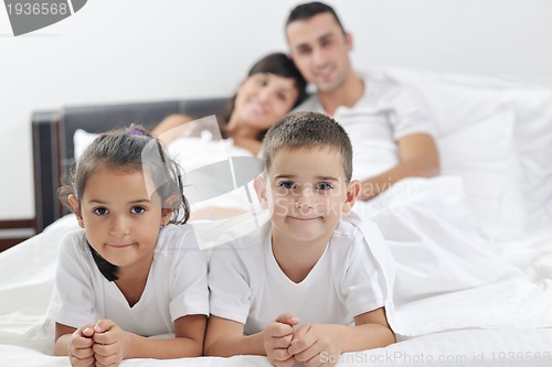Image of happy young Family in their bedroom